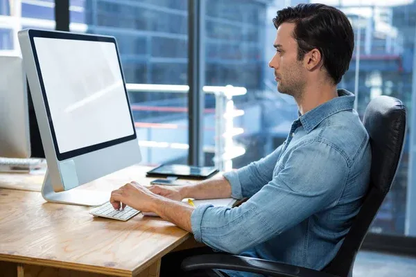 depositphotos_141552226-stock-photo-man-working-on-desktop-pc