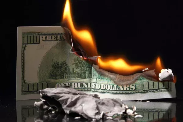 depositphotos_63680741-stock-photo-dollars-in-fire-burning-dollar