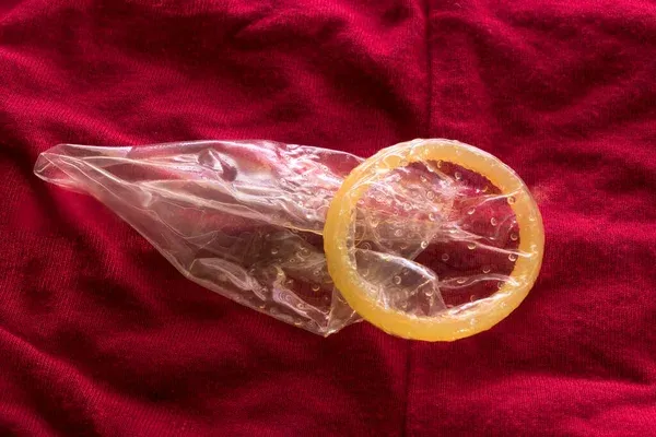 depositphotos_505171845-stock-photo-man-unrolls-condom-package